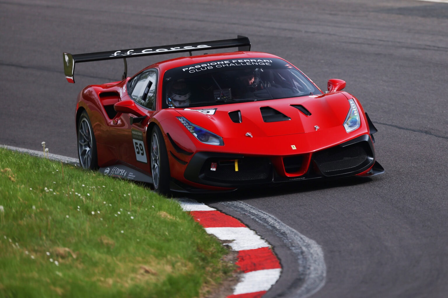 No 59 scarlet Ferrari 488 using all of the track in the Ferrari Club Challenge