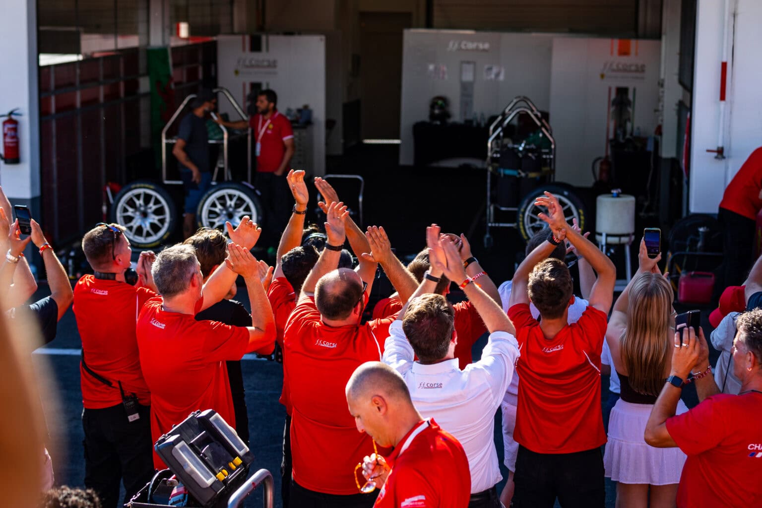 Members of the FF Corse Support Team in the pit lane